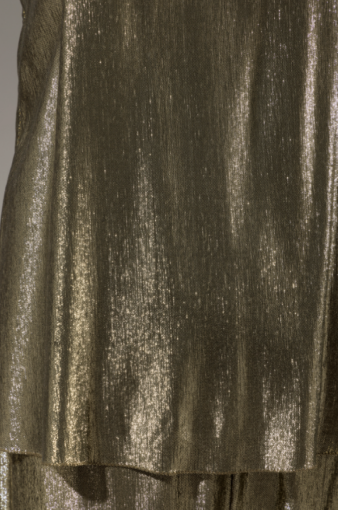 Close up of fabric on evening set in synthetic gold lamé 